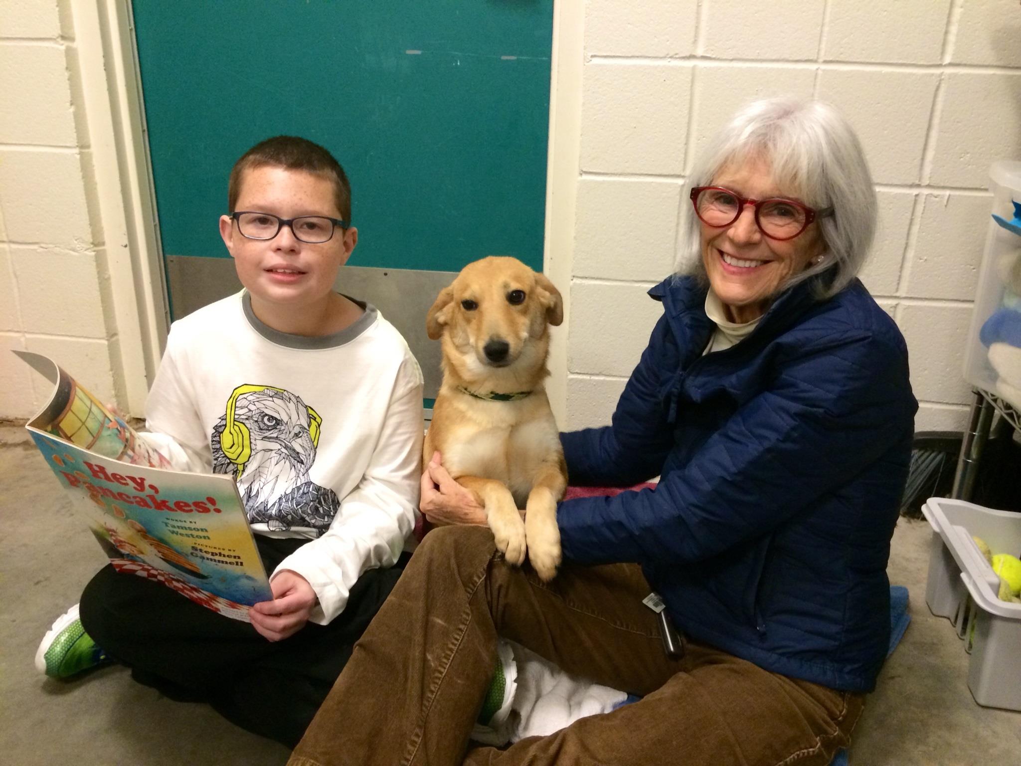 Volunteer Karen helps out during a FOTAS Dog Ears Reading session. This recurring event gives children an opportunity to read to the shelter animals.