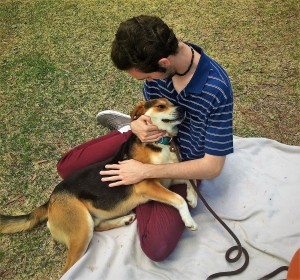 DAMON HELPS A STUDENT RELAX DURING USC AIKEN PET A PUP EVENT