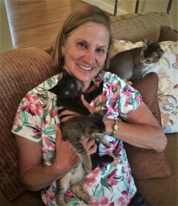 FOTAS Volunteer Debbie Snyder at home with her three foster kittens.