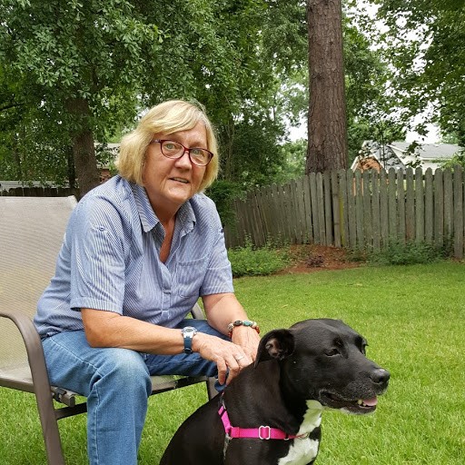 Patty McDonagh and her new canine companion, Roxy, relax in their backyard.