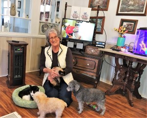Leah Holt at home with her adopted County Shelter cats Footie and Nutmeg, and dogs Chrissie and BJ. 