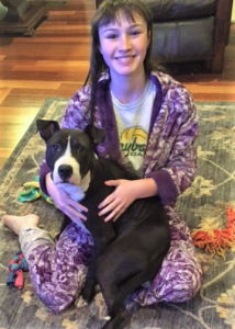 Becca Babineau at home with foster dog, Max.
